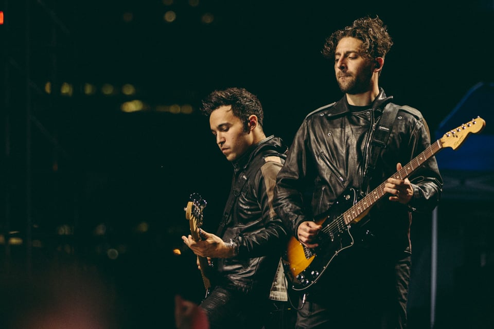 Pete Wentz and Joe Trohman of Fall Out Boy performing
